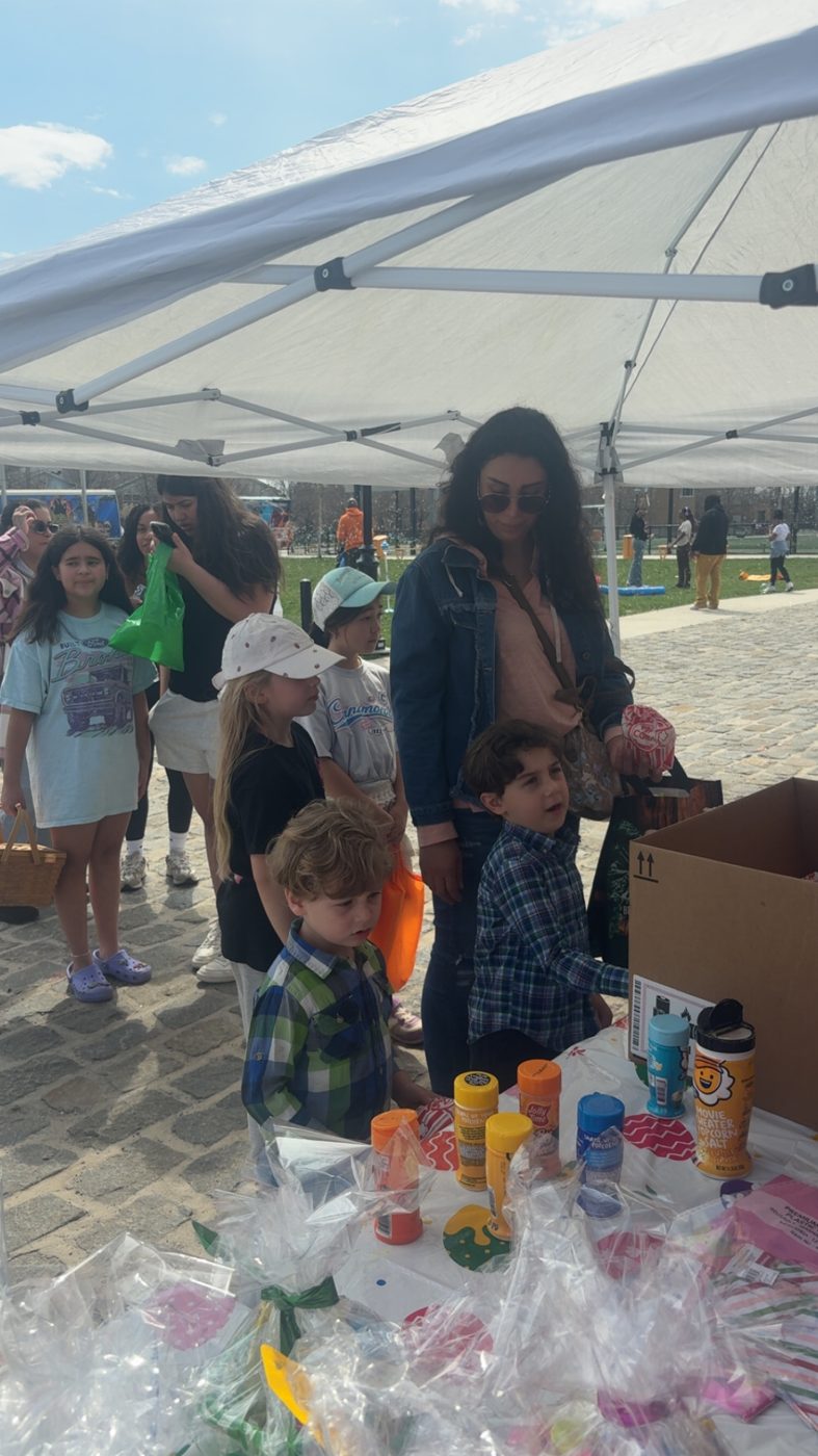 Volunteers smiling with the Easter Bunny at the egg hunt