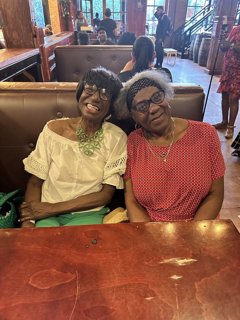 Two longtime community members seated side by side at the fundraiser