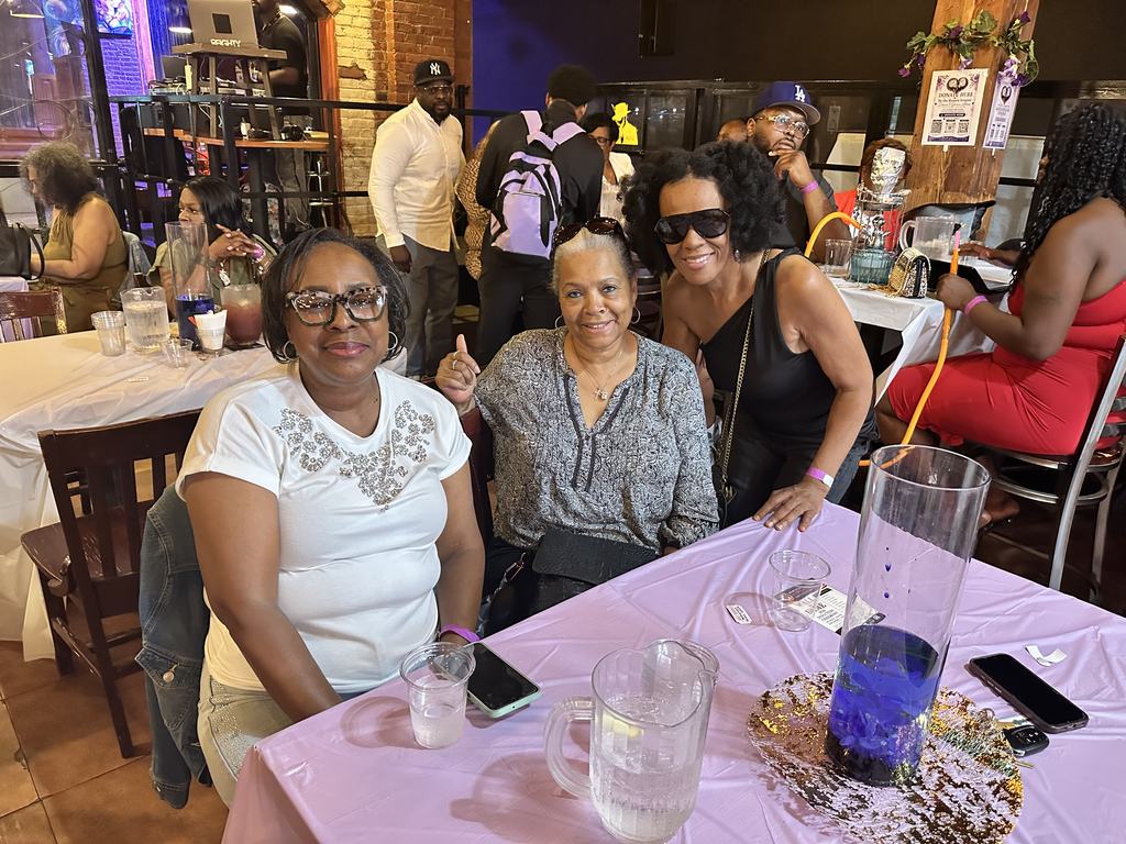 Guests smiling together at a table at the Gift of Life Fundraiser