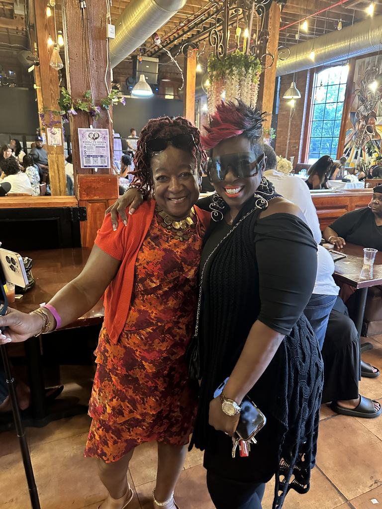 Two guests sharing a warm greeting at the fundraiser