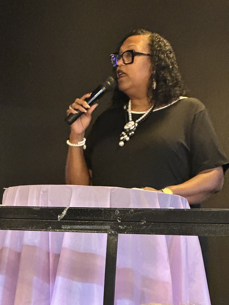 A speaker addressing guests during the evening program