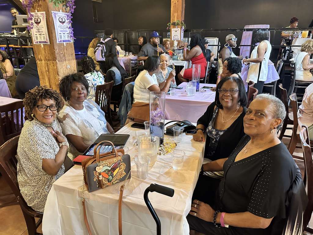 Guests smiling together at a table during the Gift of Life Fundraiser