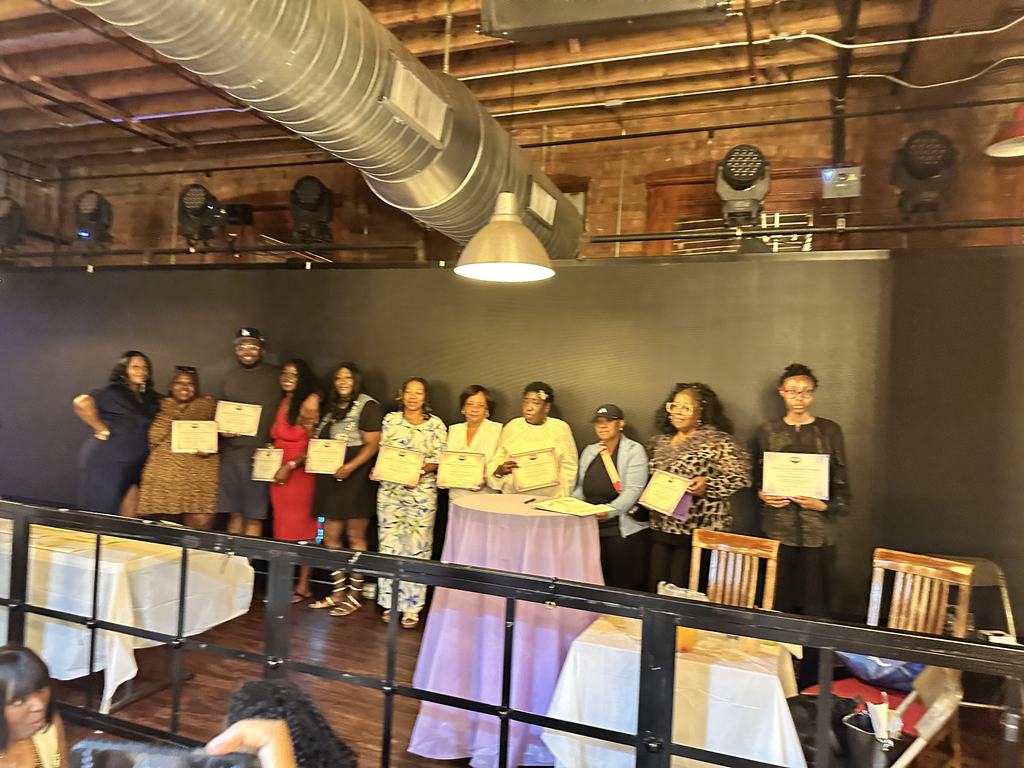 Honorees standing together with their Certificates of Commitment to Healing