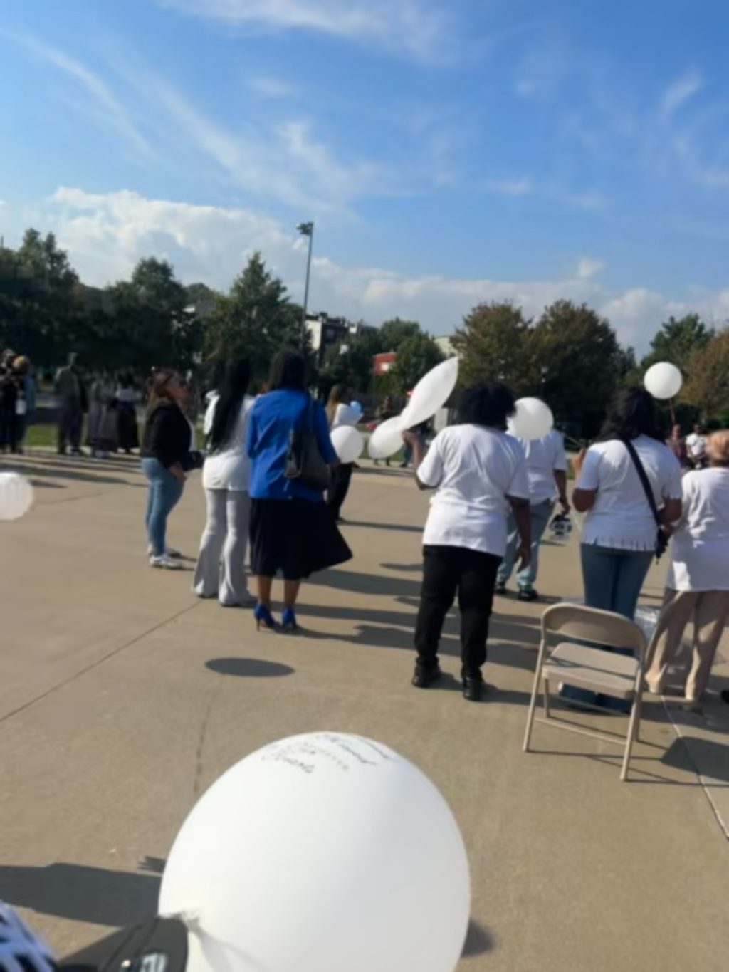 Community holding white balloons at the National Night event