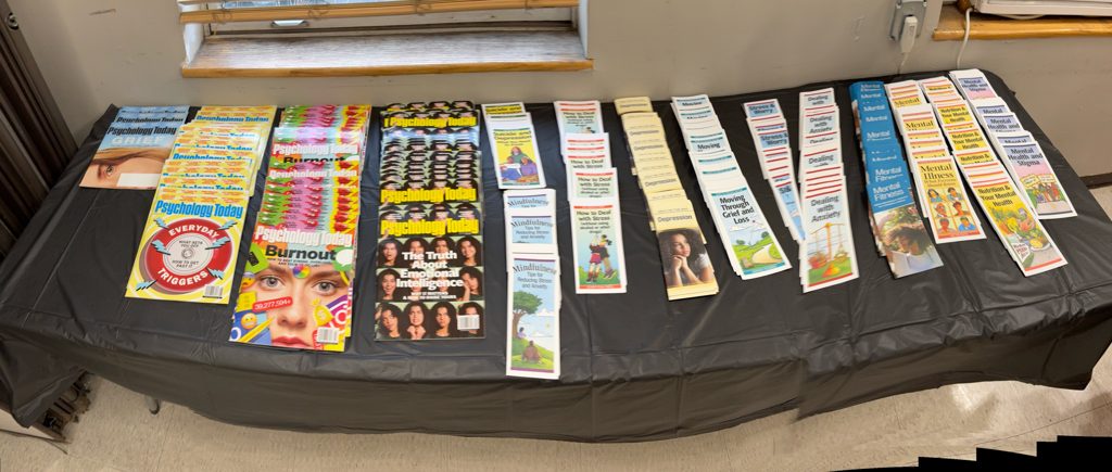 Mental health and grief resource table with magazines and pamphlets
