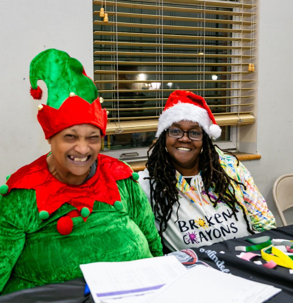 Volunteers in holiday costumes welcoming families